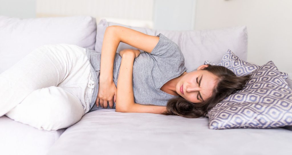Woman Lying in Bed Due to Irritable Bowel Syndrome